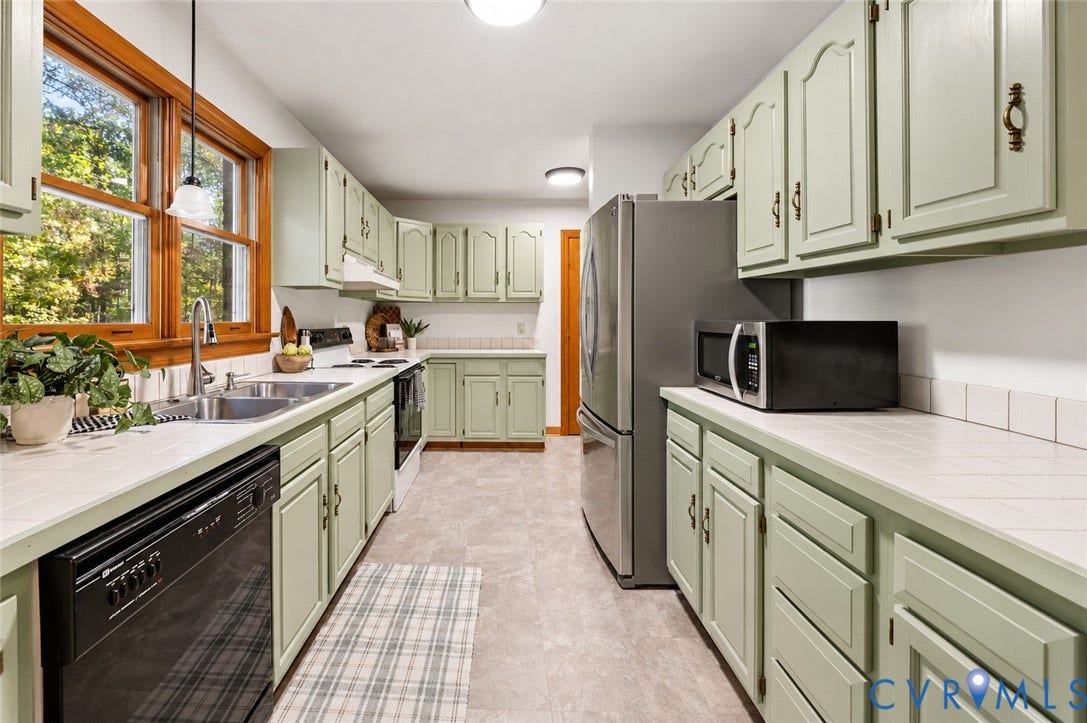 3621 Jefferson Highway, Mineral, VA 23093 Kitchen featuring painted cabinetry, tiled countertops, double-basin stainless steel sink with pull-down faucet, and wood-framed window