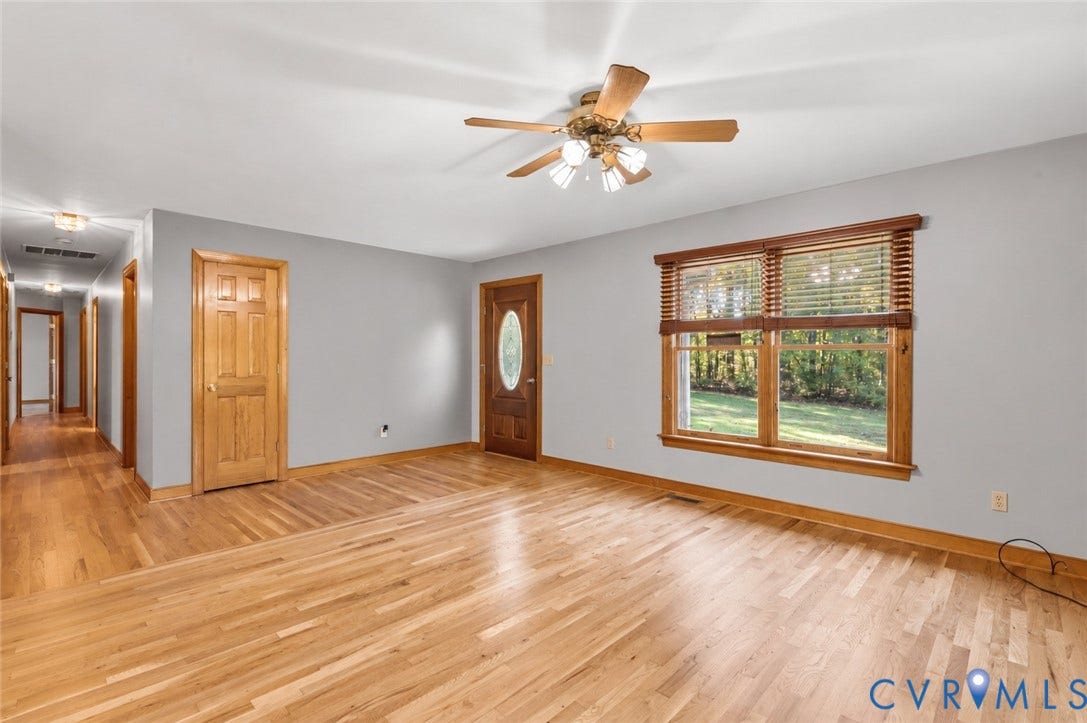3621 Jefferson Highway, Mineral, VA 23093 Interior space featuring wood-finish flooring, solid wood doors, and a ceiling fan with integrated light fixture