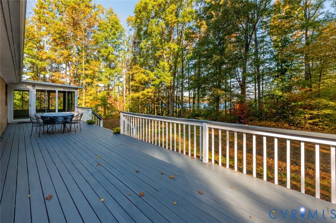 3621 Jefferson Highway, Mineral, VA 23093 Expansive deck with white railings, screened-in porch, and mature trees