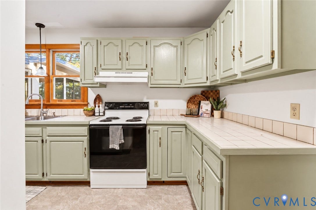 3621 Jefferson Highway, Mineral, VA 23093 Kitchen featuring sage green cabinetry, white tiled countertops, tiled backsplash, built-in range, and a dual-basin stainless steel sink with a goose-neck faucet