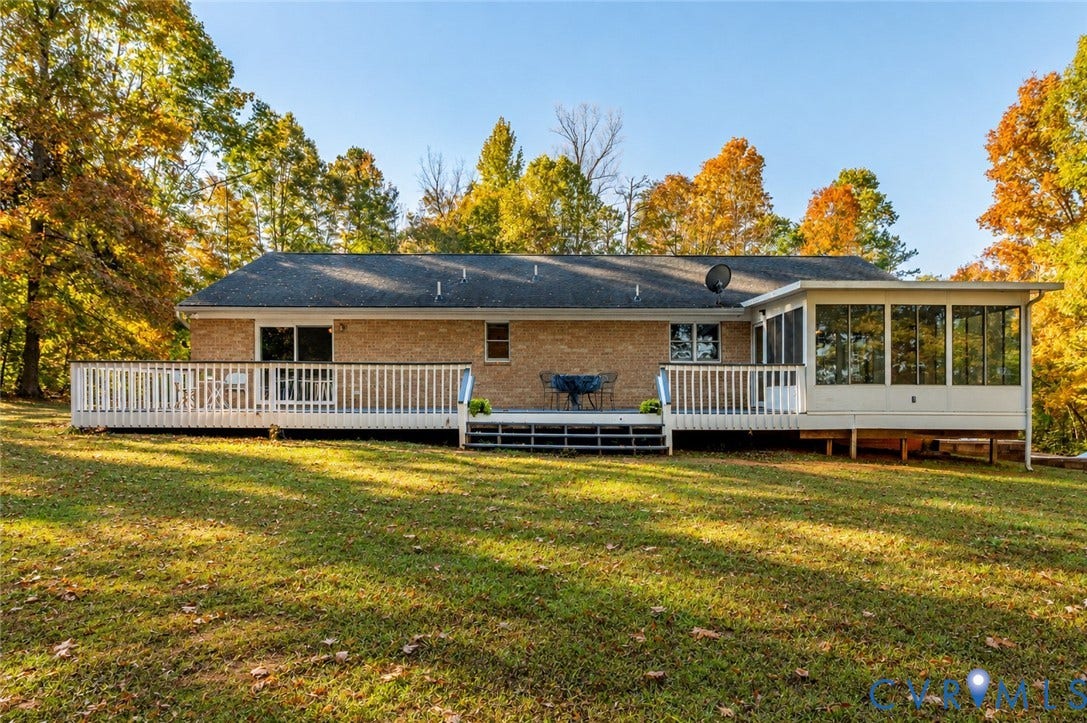 3621 Jefferson Highway, Mineral, VA 23093 Brick exterior featuring a spacious wooden deck, screen-enclosed porch, and expansive lawn