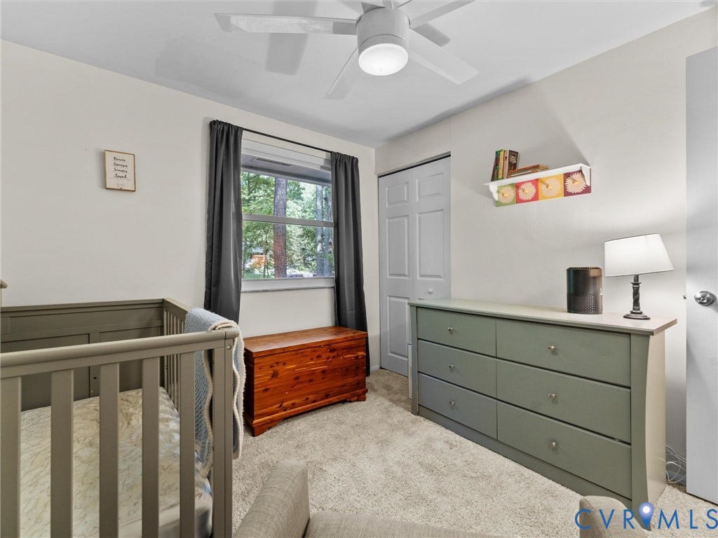 2703 Sutters Mill Court, Sutters Mill, Chesterfield, VA 23112 Neutral-toned interior featuring carpeted flooring, a ceiling fan with integrated lighting, a single-pane window, and a built-in closet with paneled doors