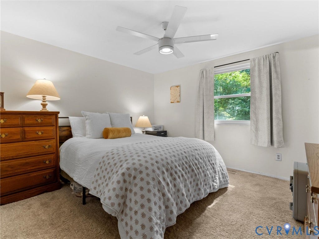2703 Sutters Mill Court, Sutters Mill, Chesterfield, VA 23112 Neutral-toned bedroom featuring plush wall-to-wall carpeting, a multi-blade ceiling fan with integrated lighting, and a single-pane window