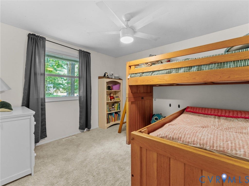 2703 Sutters Mill Court, Sutters Mill, Chesterfield, VA 23112 Neutral-toned room featuring wall-to-wall carpeting, a multi-blade ceiling fan with integrated lighting, and a single-pane window