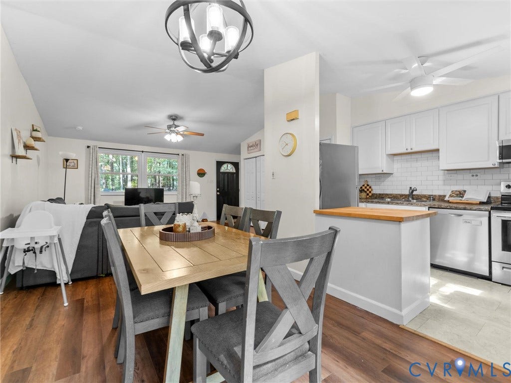 2703 Sutters Mill Court, Sutters Mill, Chesterfield, VA 23112 Open-concept living space featuring wood-finish flooring, white shaker-style cabinetry, subway tile backsplash, and a spherical chandelier