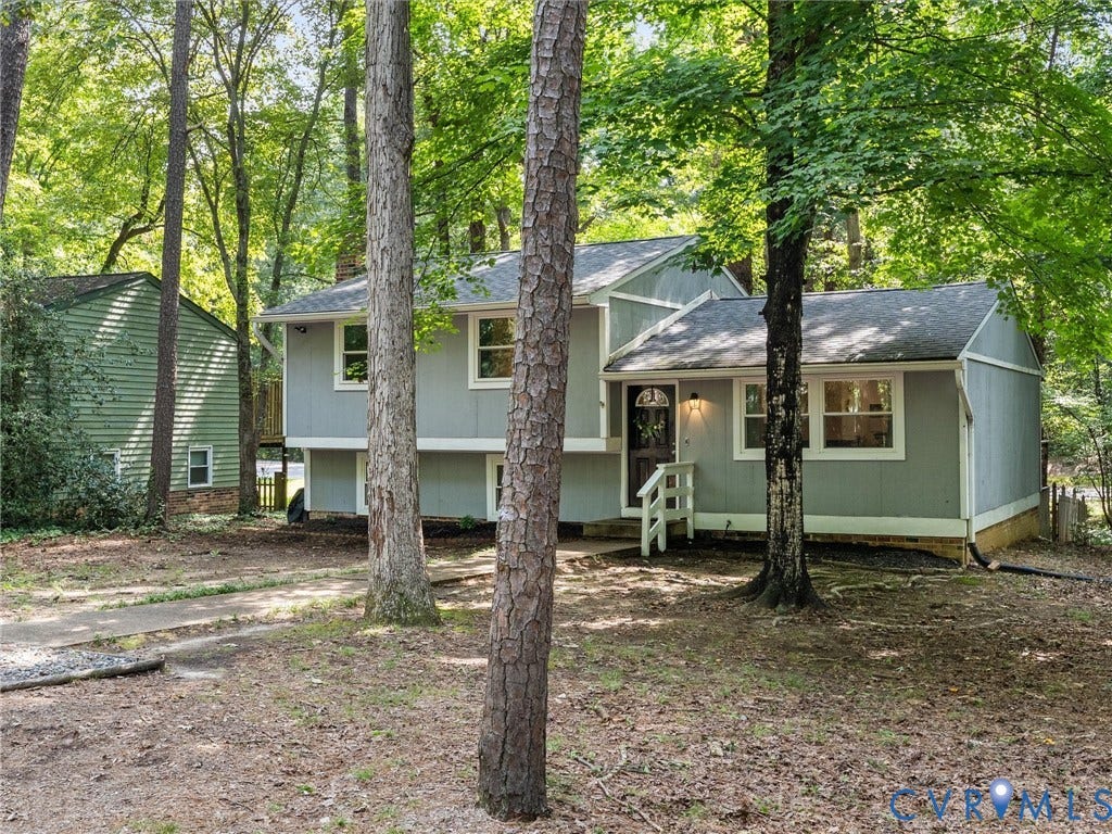 2703 Sutters Mill Court, Sutters Mill, Chesterfield, VA 23112 Split-level exterior with gray siding, asphalt shingle roof, multi-pane windows, and a paved walkway