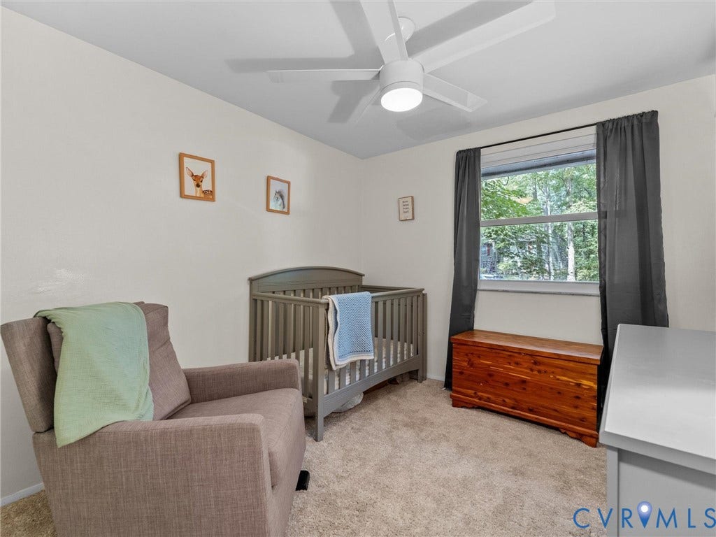 2703 Sutters Mill Court, Sutters Mill, Chesterfield, VA 23112 Neutral interior room featuring neutral carpeting, a white ceiling fan with integrated lighting, and a single-pane window
