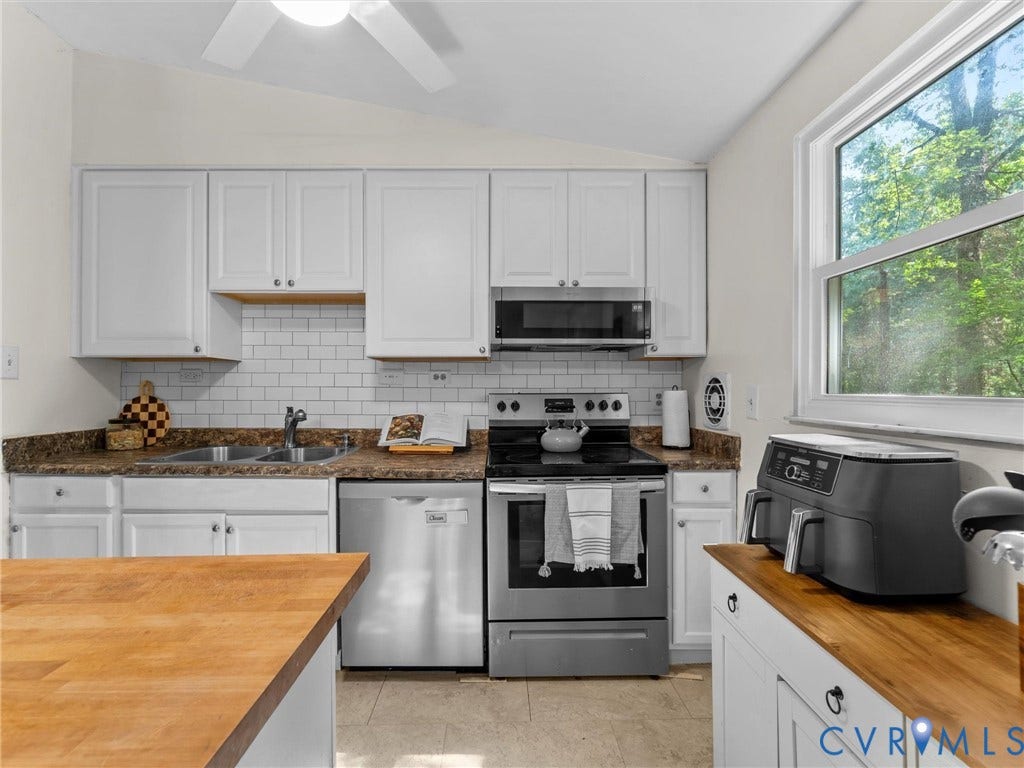 2703 Sutters Mill Court, Sutters Mill, Chesterfield, VA 23112 Kitchen featuring white cabinetry, subway tile backsplash, stainless steel appliances, butcher block countertops, and a double-basin sink