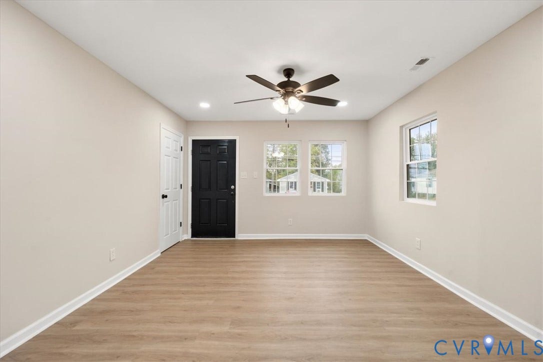 524 St Matthew Street, The Heights, Petersburg, VA 23803 Neutral-toned interior featuring wood-finish flooring, recessed lighting, a ceiling fan with integrated lighting, dual-pane windows, and a contrasting black entry door