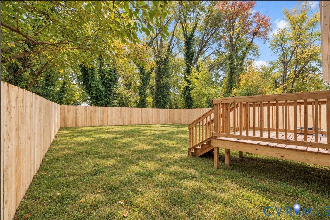 524 St Matthew Street, The Heights, Petersburg, VA 23803 Backyard featuring a wood privacy fence, elevated wooden deck with stairs, and mature trees