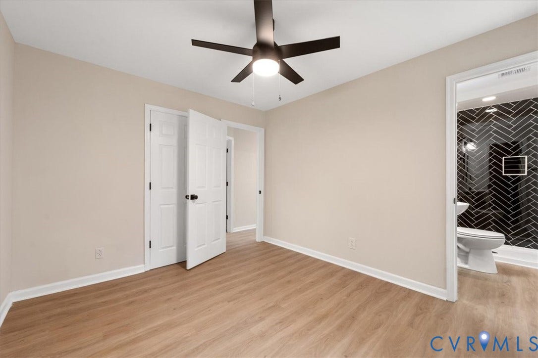 524 St Matthew Street, The Heights, Petersburg, VA 23803 Interior space featuring wood-finish flooring, a matte black multi-blade ceiling fan with integrated lighting, and a neutral color palette
