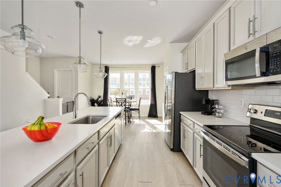 640 Rivanna Hill Road, Glen Allen, VA 23060 This view highlights the kitchens generous island workspace, built-in dishwasher, and abundant cabinet storage, with easy access to the adjoining dining area.