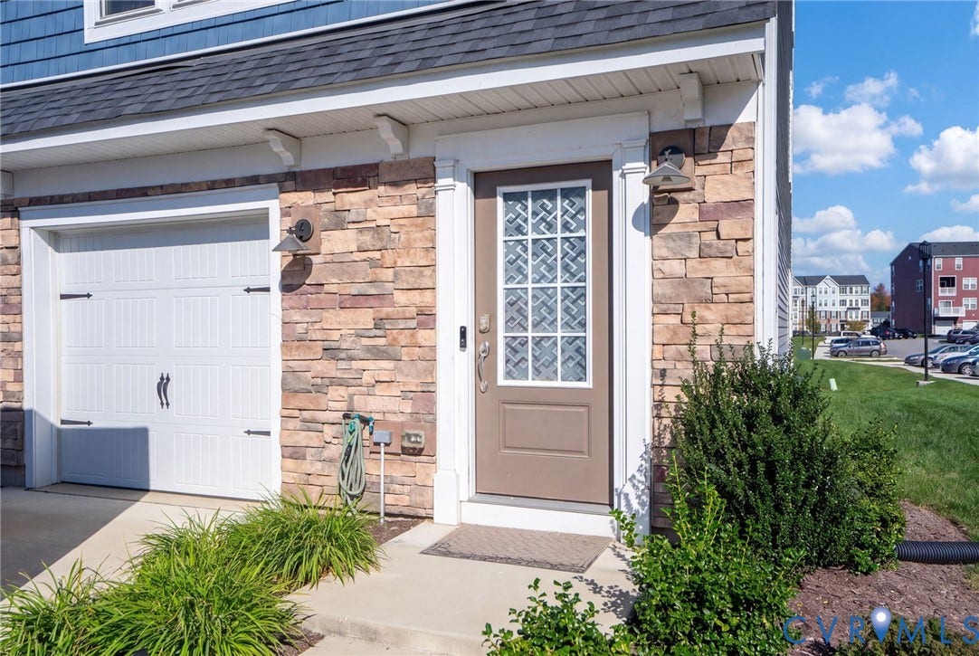 640 Rivanna Hill Road, Glen Allen, VA 23060 A glass-paneled front door, stone accents, and landscaped planting beds create a welcoming entrance beside the attached one-car garage.