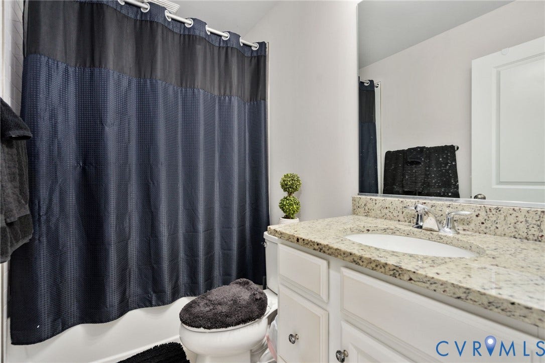 640 Rivanna Hill Road, Glen Allen, VA 23060 The full hall bath features a tub and shower combination, a spacious vanity countertop, and cabinet storage.