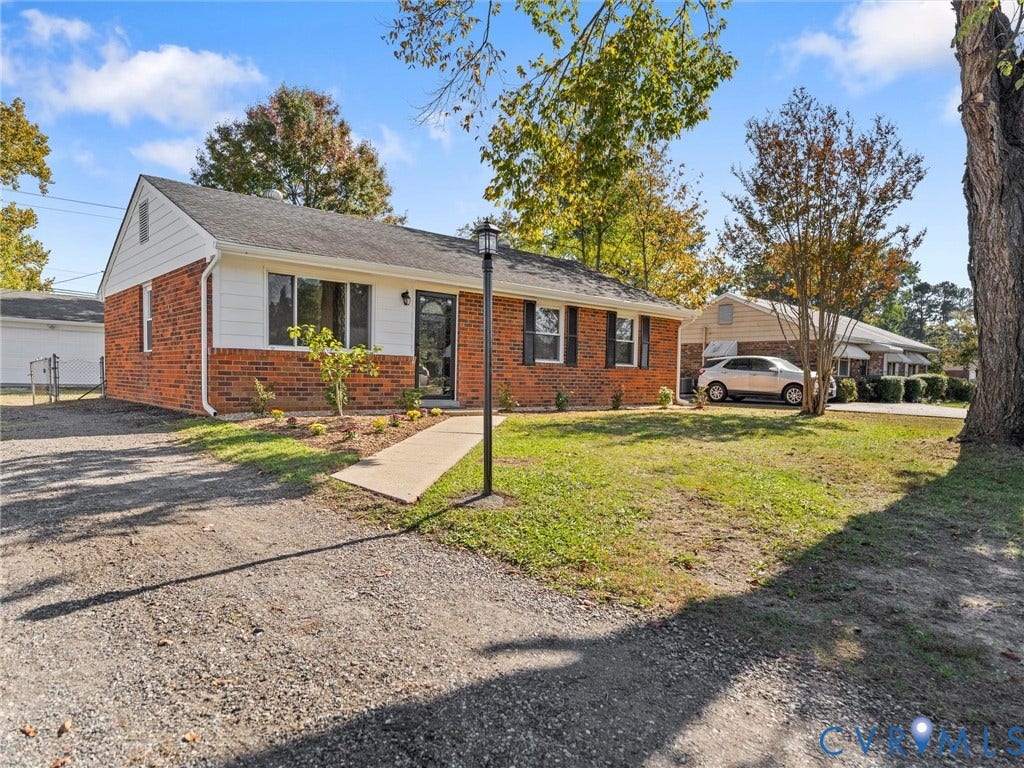 3303 Jowin Lane, Henrico, VA 23223 Single-story brick and siding exterior featuring a gable roof, decorative window shutters, and a concrete walkway