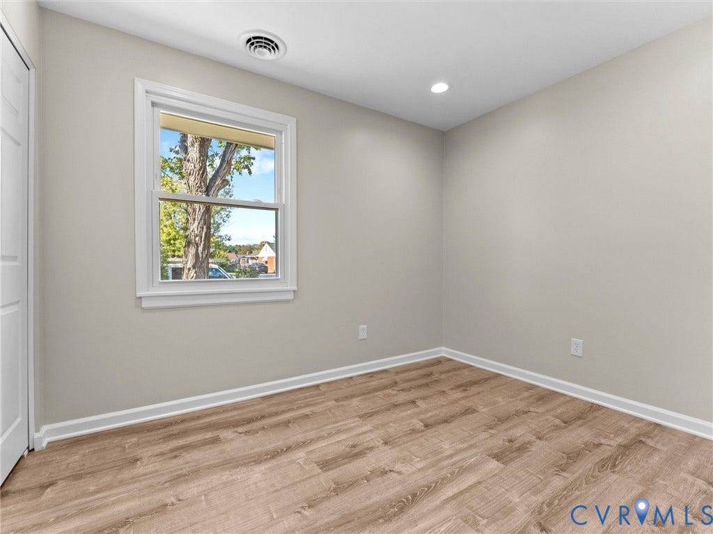 3303 Jowin Lane, Henrico, VA 23223 Neutral-toned interior room featuring wood-finish flooring, recessed lighting, and a double-pane window