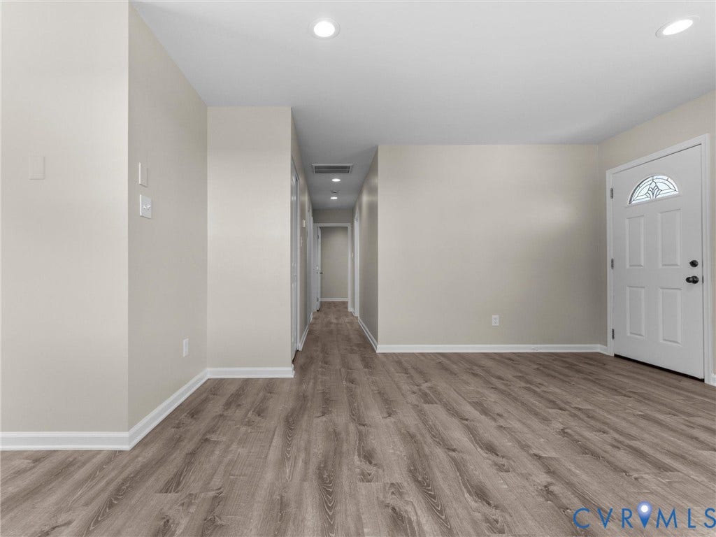 3303 Jowin Lane, Henrico, VA 23223 Interior space featuring wood-finish flooring, neutral wall paint, recessed lighting, and a six-panel exterior door with an arched decorative glass insert