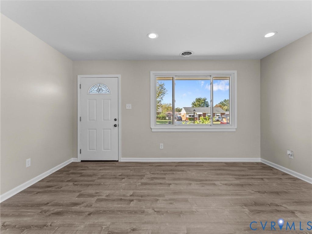 3303 Jowin Lane, Henrico, VA 23223 Interior space featuring wood-finish flooring, neutral wall paint, recessed lighting, and a six-panel exterior door with a semi-circular transom window