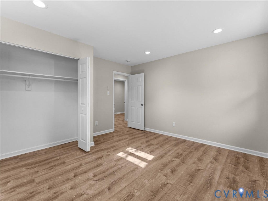 3303 Jowin Lane, Henrico, VA 23223 Neutral-toned interior featuring wood-finish flooring, recessed lighting, and a bi-fold closet door