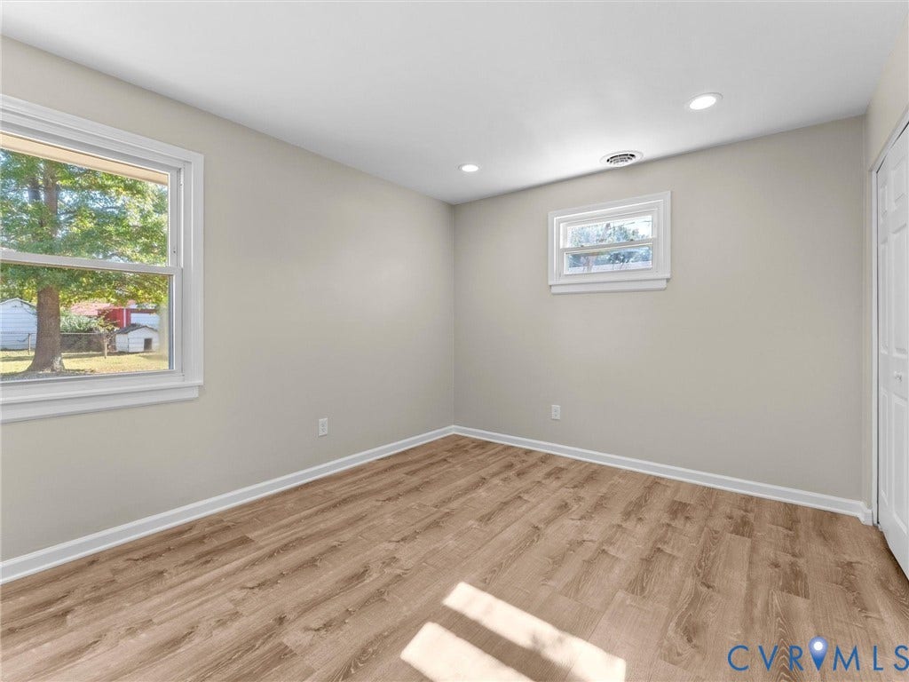 3303 Jowin Lane, Henrico, VA 23223 Neutral-toned interior room featuring wood-finish flooring, recessed lighting, and white paneled doors