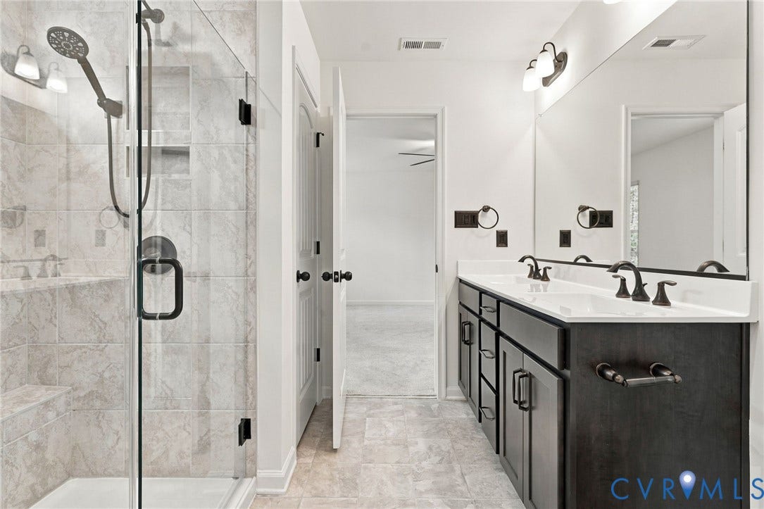 7712 Hawthorne Avenue, Henrico, VA 23227 Walk-in shower with floor-to-ceiling tile, frameless glass enclosure, and built-in shelving