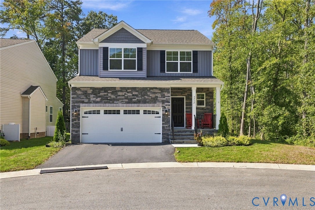 7712 Hawthorne Avenue, Henrico, VA 23227 Two-story exterior featuring stone veneer siding, a front-facing gable roof, shuttered windows, and an attached two-car garage