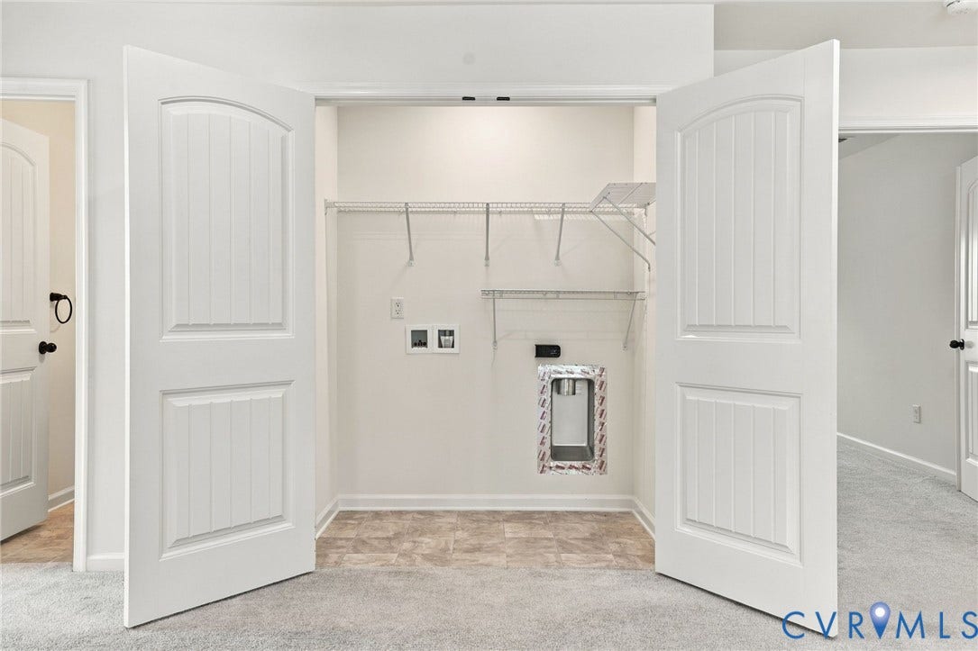 7712 Hawthorne Avenue, Henrico, VA 23227 Laundry closet featuring dual-panel interior doors, vinyl tile flooring, wire shelving, and dedicated utility hookups