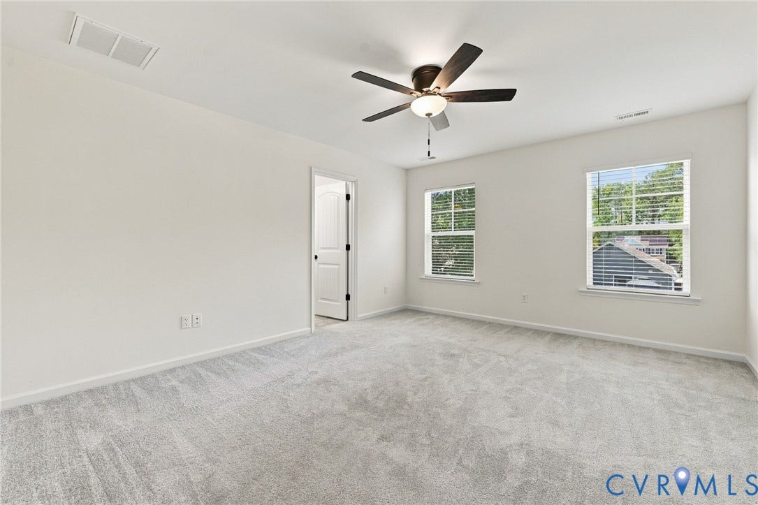7712 Hawthorne Avenue, Henrico, VA 23227 Neutral-toned carpeting, dual windows, ceiling fan with integrated lighting, and interior door with matte black hardware