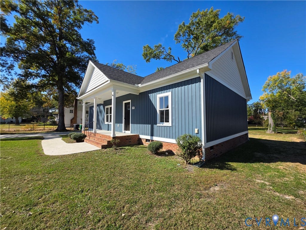 3005 Portsmouth Street, Hopewell, VA 23860 Single-story residence featuring vertical siding, a brick foundation, a covered front porch, and a concrete walkway