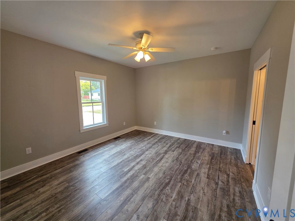 3005 Portsmouth Street, Hopewell, VA 23860 Room featuring wood-finish flooring, neutral wall paint, a single-window configuration, and a ceiling fan with integrated lighting