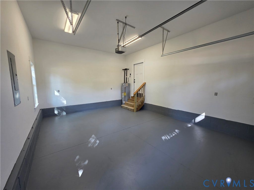 3005 Portsmouth Street, Hopewell, VA 23860 Finished garage featuring epoxy-coated flooring, painted masonry walls, overhead lighting fixtures, and built-in mechanical components