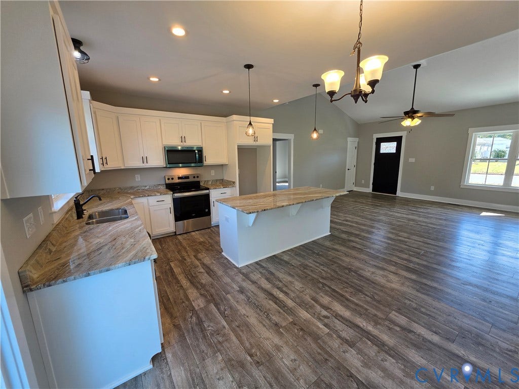 3005 Portsmouth Street, Hopewell, VA 23860 Kitchen featuring white cabinetry, stone-surface countertops, a center island, stainless steel appliances, and wood-finish flooring