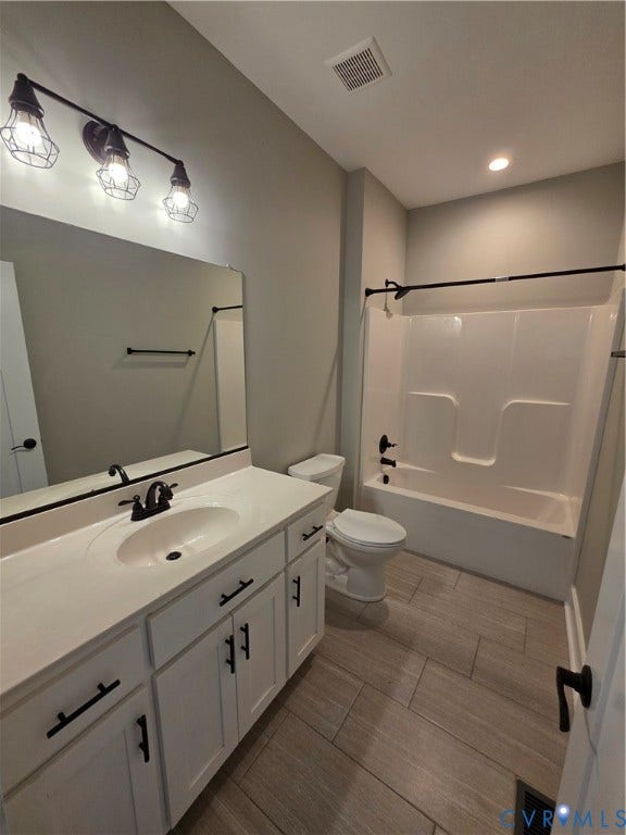 3005 Portsmouth Street, Hopewell, VA 23860 White cabinetry featuring matte black hardware, stone-finish countertop with an integrated oval sink, three-light industrial-style fixture, and wood-finish tile flooring