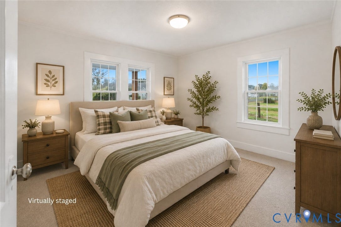 Bedroom featuring neutral wall-to-wall carpeting, three double-hung windows with white millwork trim, and a ceiling-mounted light fixture