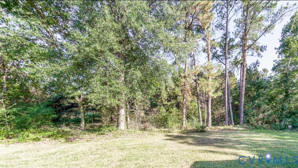 4130 Cogbill Road, Ampthill, VA 23234 Expansive grass lawn featuring mature trees and established perimeter foliage