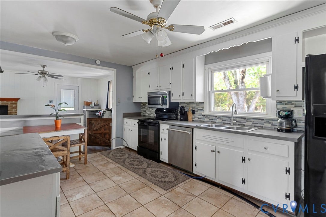 8444 New London Road, Mechanicsville, VA 23116 Kitchen featuring white cabinetry, stainless steel appliances, multi-toned tile backsplash, solid-surface countertops, and tile flooring