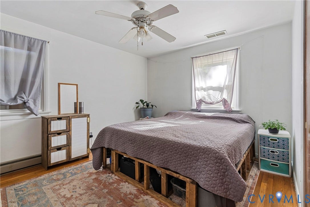 8444 New London Road, Mechanicsville, VA 23116 Bedroom featuring wood-finish flooring, white walls, and a ceiling fan with integrated light fixture