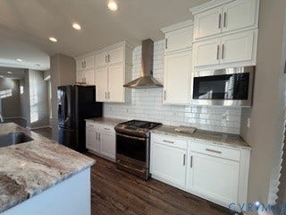 2144 Perennial Circle, Henrico, VA 23233 Kitchen featuring shaker-style white cabinetry, stone-finish countertops, stainless steel appliances, a tile backsplash, and wood-finish flooring