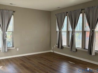 2144 Perennial Circle, Henrico, VA 23233 Neutral-toned interior space featuring wood-finish flooring and multiple large windows with installed blinds
