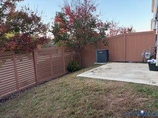 2144 Perennial Circle, Henrico, VA 23233 Rear outdoor space featuring a concrete patio, horizontal-slat privacy fencing, and mature trees
