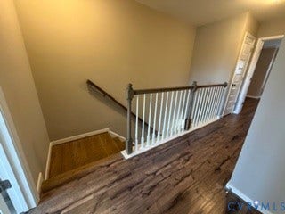 2144 Perennial Circle, Henrico, VA 23233 Hallway featuring wood-finish flooring, a wooden handrail, and a white baluster railing