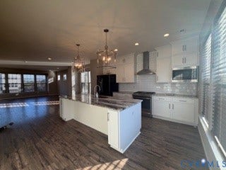 2144 Perennial Circle, Henrico, VA 23233 Kitchen featuring white cabinetry, stone-surface island, wood-finish flooring, subway tile backsplash, and stainless steel appliances