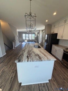 2144 Perennial Circle, Henrico, VA 23233 Kitchen featuring a center island with a natural stone countertop, white shaker-style cabinetry, wood-finish flooring, and a suspended lantern-style pendant light