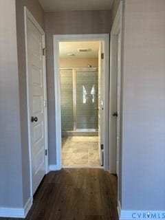 2144 Perennial Circle, Henrico, VA 23233 Four-panel interior doors, wood-finish flooring, and a walk-in shower enclosure with a glass door and tiled surround
