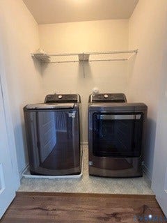 2144 Perennial Circle, Henrico, VA 23233 Laundry alcove featuring dark metallic-finish appliances, a protective floor drip tray, and a white wire-grid overhead storage shelf