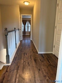 2144 Perennial Circle, Henrico, VA 23233 Hallway featuring wood-finish flooring, a white balustrade with dark-finished newel posts, and a dome-style flush mount ceiling light