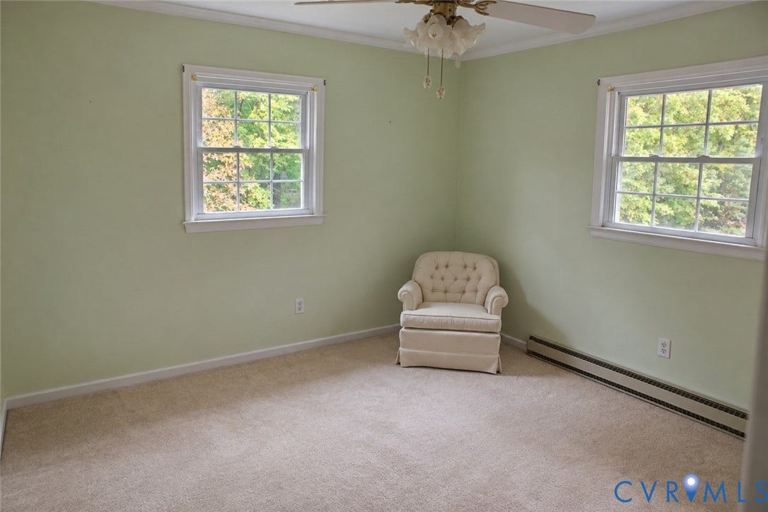 9711 Old Stage Road, Prince George, VA 23875 Room featuring wall-to-wall carpeting, two double-hung windows with exterior greenery, and a ceiling-mounted light fixture with fan