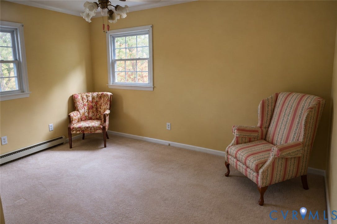 9711 Old Stage Road, Prince George, VA 23875 Room featuring neutral carpeting, double-hung windows, and a multi-light ceiling fixture