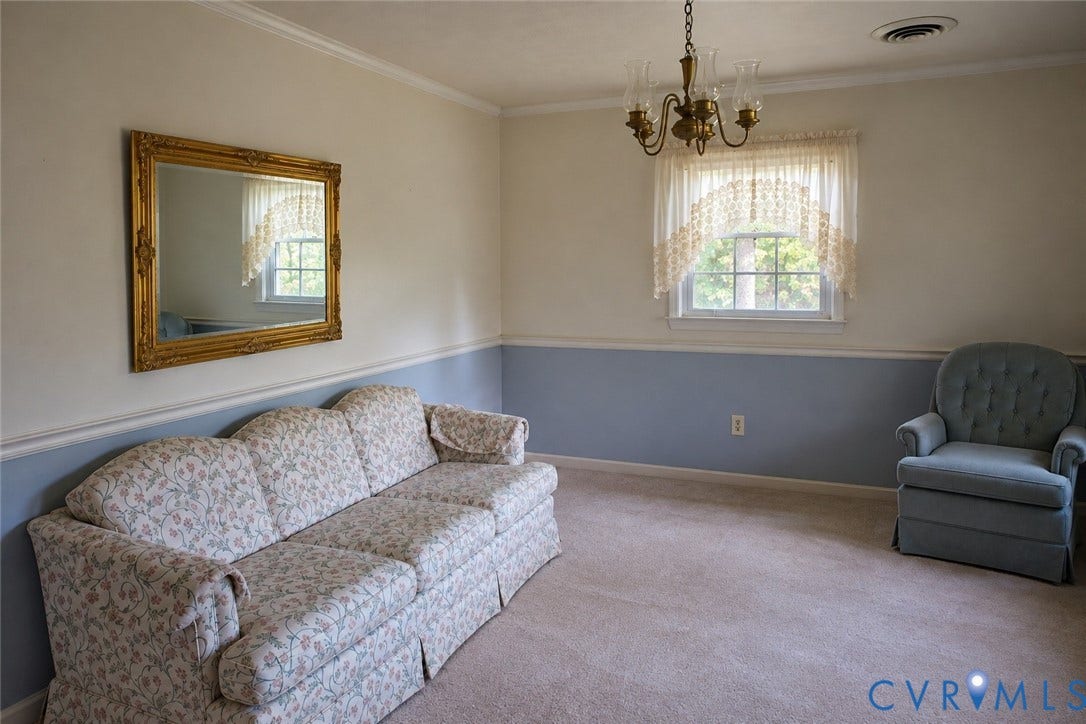 9711 Old Stage Road, Prince George, VA 23875 Multi-toned wall paint separated by chair rail molding, carpeted flooring, multi-pane window with valance, and a multi-arm metallic chandelier