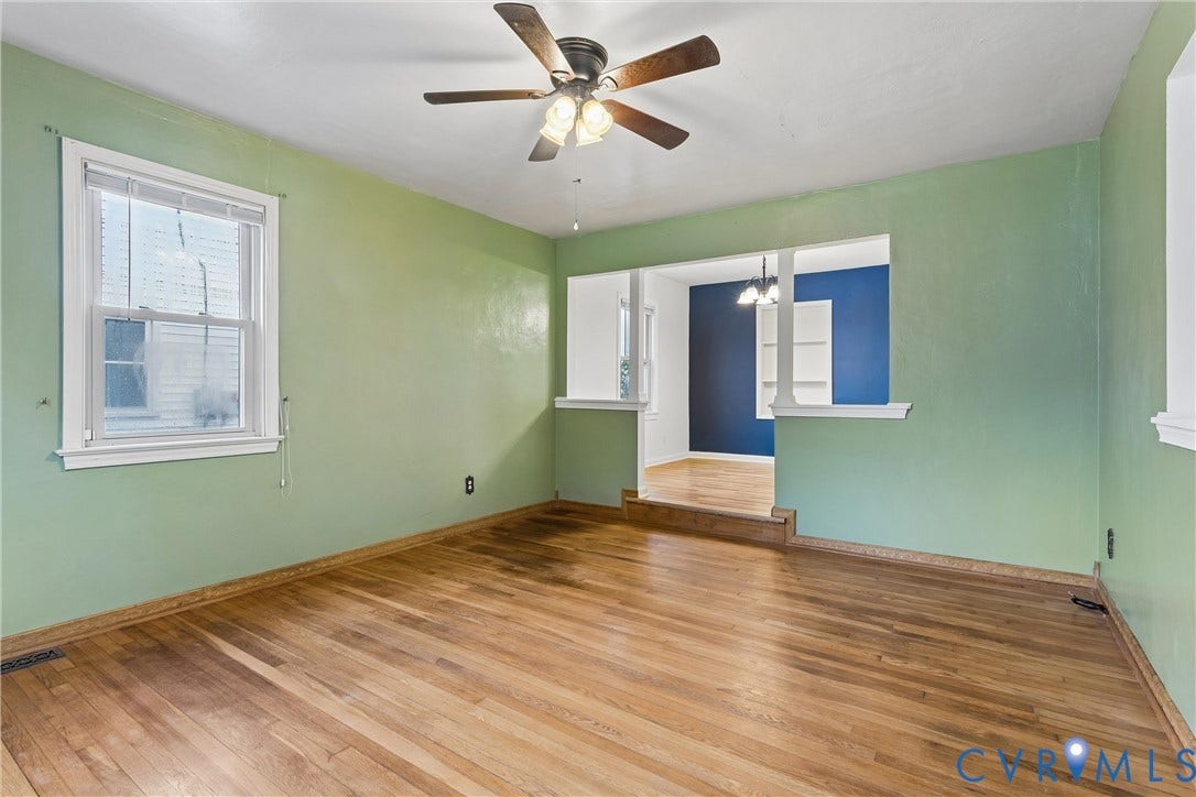 627 Sedgefield Drive, 992- All Others Area 107, Newport News, VA 23605 Interior room featuring wood-finish flooring, a ceiling fan with integrated lighting, multi-pane window, and a partial partition wall with a column
